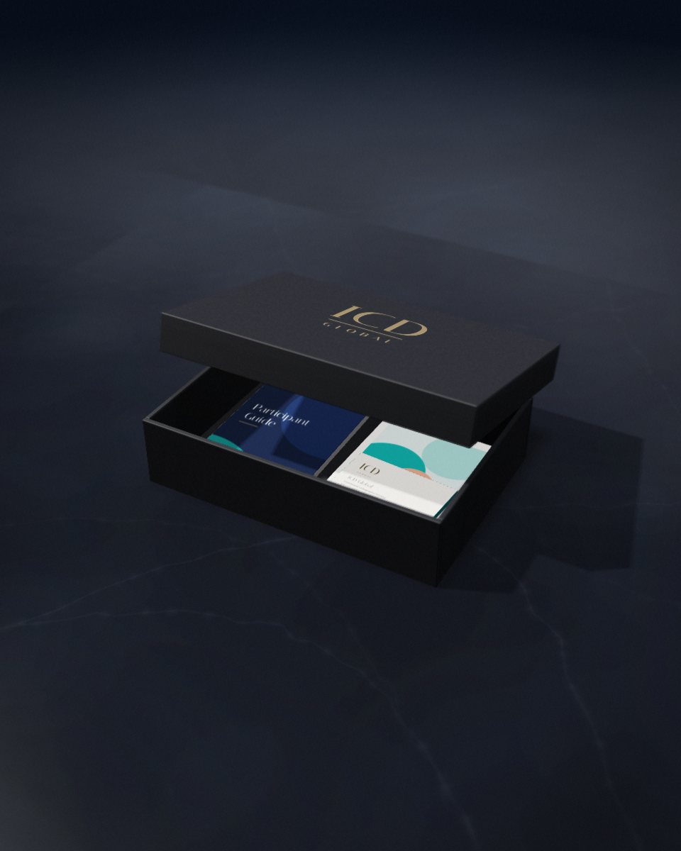 A matte black presentation box, lid lifted, holding a participant guide and printed flyers